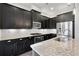 Well-equipped kitchen featuring stainless steel appliances, granite countertops and dark cabinets at 891 Proctor Oaks Nw St, Atlanta, GA 30318
