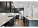 Modern kitchen with granite countertops, stainless steel appliances, and dark wood cabinetry at 891 Proctor Oaks Nw St, Atlanta, GA 30318