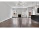 Open living area with fireplace, wood floors, and an open layout into the kitchen at 891 Proctor Oaks Nw St, Atlanta, GA 30318