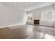 Spacious living room with wood floors, fireplace, modern lighting, and ample natural light at 891 Proctor Oaks Nw St, Atlanta, GA 30318