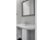 Elegant pedestal sink and decorative mirror create a stylish powder room at 891 Proctor Oaks Nw St, Atlanta, GA 30318