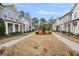 Neighborhood street view showcasing well-maintained townhouses and green spaces at 891 Proctor Oaks Nw St, Atlanta, GA 30318