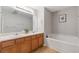 Bright bathroom featuring double sinks, a large mirror, and a relaxing soaking tub at 2280 Baker Station Dr, Acworth, GA 30101