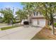 A well-manicured townhome showcasing a two-car garage, lush greenery, and a welcoming facade at 2280 Baker Station Dr, Acworth, GA 30101