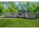 Backyard with a view of the house with a nice lawn and mature trees at 2385 Perkerson Sw Rd, Atlanta, GA 30315