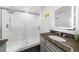 Modern bathroom featuring a granite countertop, a glass shower, and a lighted mirror at 2385 Perkerson Sw Rd, Atlanta, GA 30315