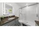 Modern bathroom featuring a granite countertop, a glass shower, and a lighted mirror at 2385 Perkerson Sw Rd, Atlanta, GA 30315