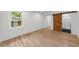 Bedroom featuring hardwood floors, white walls, large window, and a barn door entrance to the bathroom at 2385 Perkerson Sw Rd, Atlanta, GA 30315