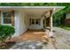 A covered carport is attached to a freshly painted home with trimmed bushes at 2385 Perkerson Sw Rd, Atlanta, GA 30315