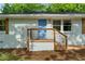 A charming updated front porch with new railings and a freshly painted blue front door at 2385 Perkerson Sw Rd, Atlanta, GA 30315