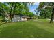 Front yard of a single-Gathering house with mature trees, green lawn, and white siding at 2385 Perkerson Sw Rd, Atlanta, GA 30315