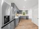 Modern kitchen with stainless steel appliances, gray cabinets, and hardwood floors at 2385 Perkerson Sw Rd, Atlanta, GA 30315