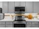 Close up of the kitchen featuring stainless appliances, grey cabinets, and light countertops at 2385 Perkerson Sw Rd, Atlanta, GA 30315