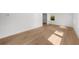 Sunlit living room featuring newly refinished hardwood floors and fresh white paint at 2385 Perkerson Sw Rd, Atlanta, GA 30315