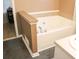Bathroom featuring a bathtub with jets, sink, tile backsplash, and a partial wall at 287 Diamond Ct, Carrollton, GA 30116