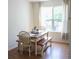 Bright dining area with natural light, wood floors, and seating for four at 287 Diamond Ct, Carrollton, GA 30116