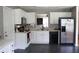 Well-lit kitchen featuring white cabinets, updated appliances, and a view from the window at 287 Diamond Ct, Carrollton, GA 30116