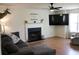 Inviting living room featuring a fireplace, mounted television, and cozy sectional sofa at 287 Diamond Ct, Carrollton, GA 30116