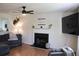 Cozy living room featuring a fireplace, ceiling fan, and comfortable seating at 287 Diamond Ct, Carrollton, GA 30116