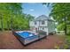 The backyard features a large in-ground pool, a wooden deck, and lush greenery, creating a private oasis at 2987 Windward Nw Dr, Kennesaw, GA 30152