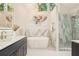 This bathroom features a soaking tub, walk-in shower, double vanities, and modern lighting at 2987 Windward Nw Dr, Kennesaw, GA 30152