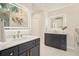 This bathroom has double vanities, modern lighting, and marble floors at 2987 Windward Nw Dr, Kennesaw, GA 30152