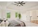 Bedroom features a tray ceiling, a ceiling fan, and two windows at 2987 Windward Nw Dr, Kennesaw, GA 30152