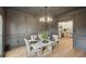 This is a dining room with a table, chairs, modern lighting, and gray walls at 2987 Windward Nw Dr, Kennesaw, GA 30152