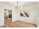 Dining room features sleek modern lighting and view to the living room with fireplace at 2987 Windward Nw Dr, Kennesaw, GA 30152