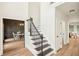 Spacious foyer with black and white staircase, hardwood floors, and views of the dining room at 2987 Windward Nw Dr, Kennesaw, GA 30152