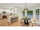 Bright kitchen featuring white cabinets, stainless steel appliances, and a breakfast bar at 2987 Windward Nw Dr, Kennesaw, GA 30152