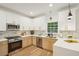 Well-lit kitchen with two-tone cabinets, stainless steel appliances, and light countertops at 2987 Windward Nw Dr, Kennesaw, GA 30152