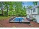 Backyard view with a fenced in-ground pool, deck, lush green trees, and a two-story home at 2987 Windward Nw Dr, Kennesaw, GA 30152