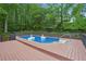 Serene in-ground pool features a spacious deck, fun swan floats, and a backdrop of lush greenery at 2987 Windward Nw Dr, Kennesaw, GA 30152