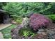 Secluded backyard with a beautiful pond, rock features, and lush landscaping at 3353 Greenfield Dr, Marietta, GA 30068