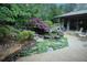Landscaped backyard with a pond, lush greenery, and a charming patio area at 3353 Greenfield Dr, Marietta, GA 30068