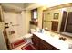 Bright bathroom featuring a walk-in shower, white tile, and a wooden vanity at 3353 Greenfield Dr, Marietta, GA 30068