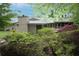 Home exterior featuring lush greenery, mature trees, and a private yard at 3353 Greenfield Dr, Marietta, GA 30068