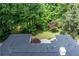 Aerial view of the home showcasing the backyard and patio area; gorgeous landscaping with mature trees at 140 Emily Sw Dr, Lilburn, GA 30047