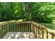Backyard wooden deck overlooking a large, well-maintained lawn and tree-lined property at 140 Emily Sw Dr, Lilburn, GA 30047