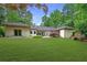 Expansive backyard features lush green grass and a charming patio, ideal for outdoor relaxation and entertainment at 140 Emily Sw Dr, Lilburn, GA 30047