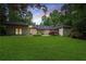 Expansive backyard with lush green lawn and established landscaping, ideal for outdoor activities at 140 Emily Sw Dr, Lilburn, GA 30047
