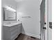 Bathroom features a gray vanity with a white marble countertop and a decorative mirror at 140 Emily Sw Dr, Lilburn, GA 30047