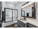 Bathroom boasts shower/tub combo and stylish vanity with granite countertop and decorative mirror at 140 Emily Sw Dr, Lilburn, GA 30047