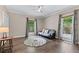 Bedroom displays hard wood floors, area rug, ceiling fan, and ample natural light at 140 Emily Sw Dr, Lilburn, GA 30047