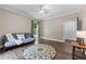 Bedroom boasts an area rug, hard wood floors, ceiling fan, and ample natural light at 140 Emily Sw Dr, Lilburn, GA 30047