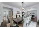 Dining room with white trim, dark wood floors, and view to the living room at 140 Emily Sw Dr, Lilburn, GA 30047