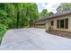 Long concrete driveway leads to the garage, providing ample parking space and easy access to the home at 140 Emily Sw Dr, Lilburn, GA 30047