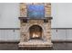 Stone fireplace with wood mantel, slate hearth and built in cabinets, with burning fire at 140 Emily Sw Dr, Lilburn, GA 30047