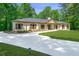 Inviting ranch-style home with a pristine driveway and manicured landscaping in a lush, green setting at 140 Emily Sw Dr, Lilburn, GA 30047